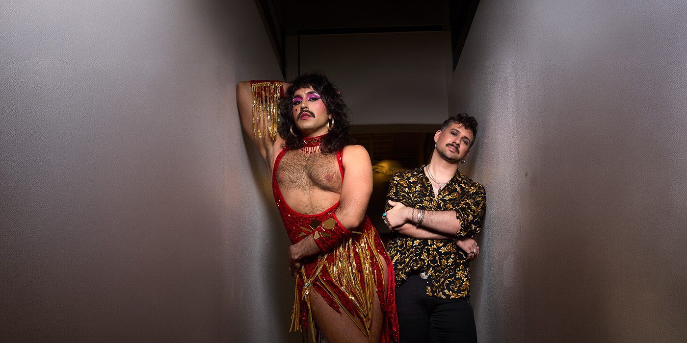 Tony and the Kiki leaning against a wall at a walkthrough, all dressed up.